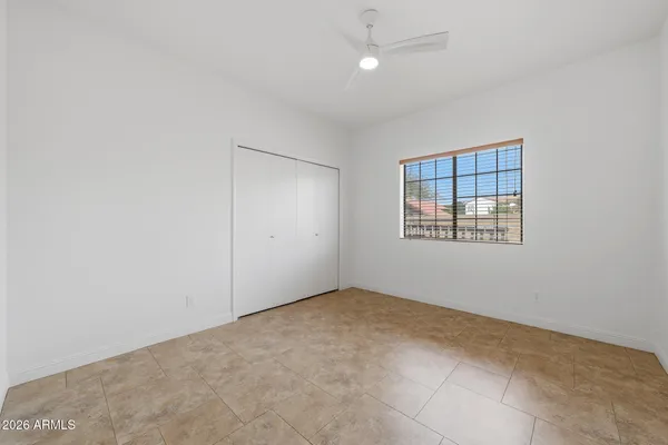 a view of a patio with a table and chairs and potted plants