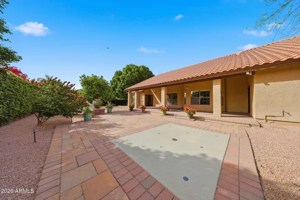 a view of house with backyard and garden