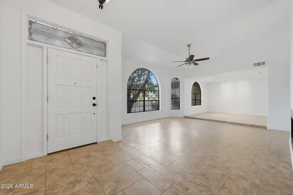 a view of a kitchen with a sink and a refrigerator