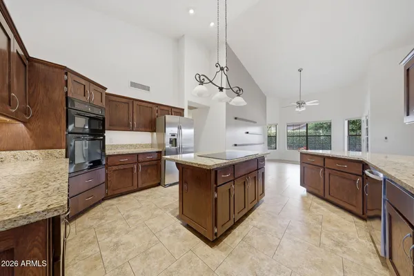 a kitchen with a stove a sink and a refrigerator