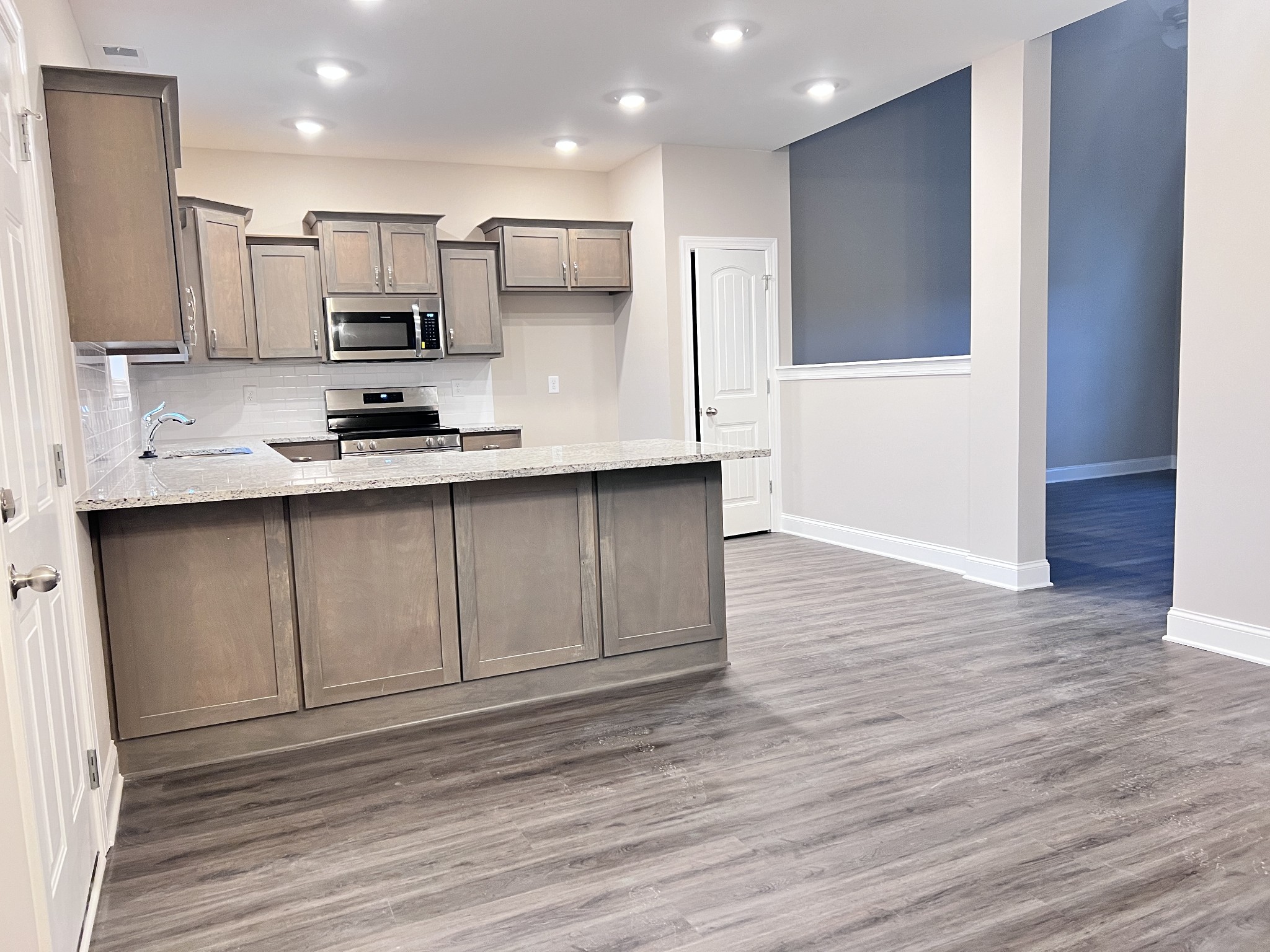 442 Generosity Way Smyrna, TN 37167 - Photo 18 of 59 a kitchen with stainless steel appliances a sink a stove a microwave and cabinets