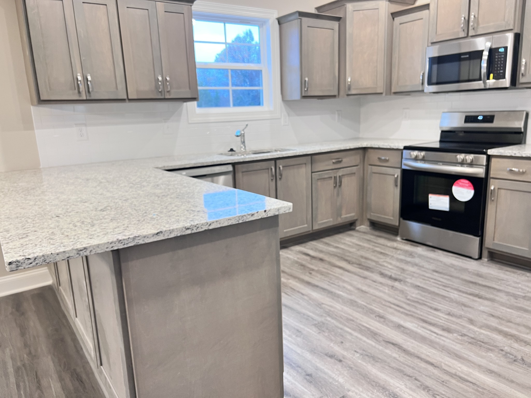 442 Generosity Way Smyrna, TN 37167 - Photo 2 of 59 a kitchen with stainless steel appliances granite countertop a sink stove and microwave