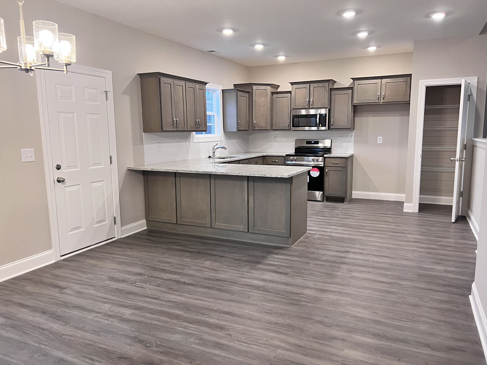 442 Generosity Way Smyrna, TN 37167 - Photo 30 of 59 a large kitchen with stainless steel appliances granite countertop a stove a sink and a refrigerator