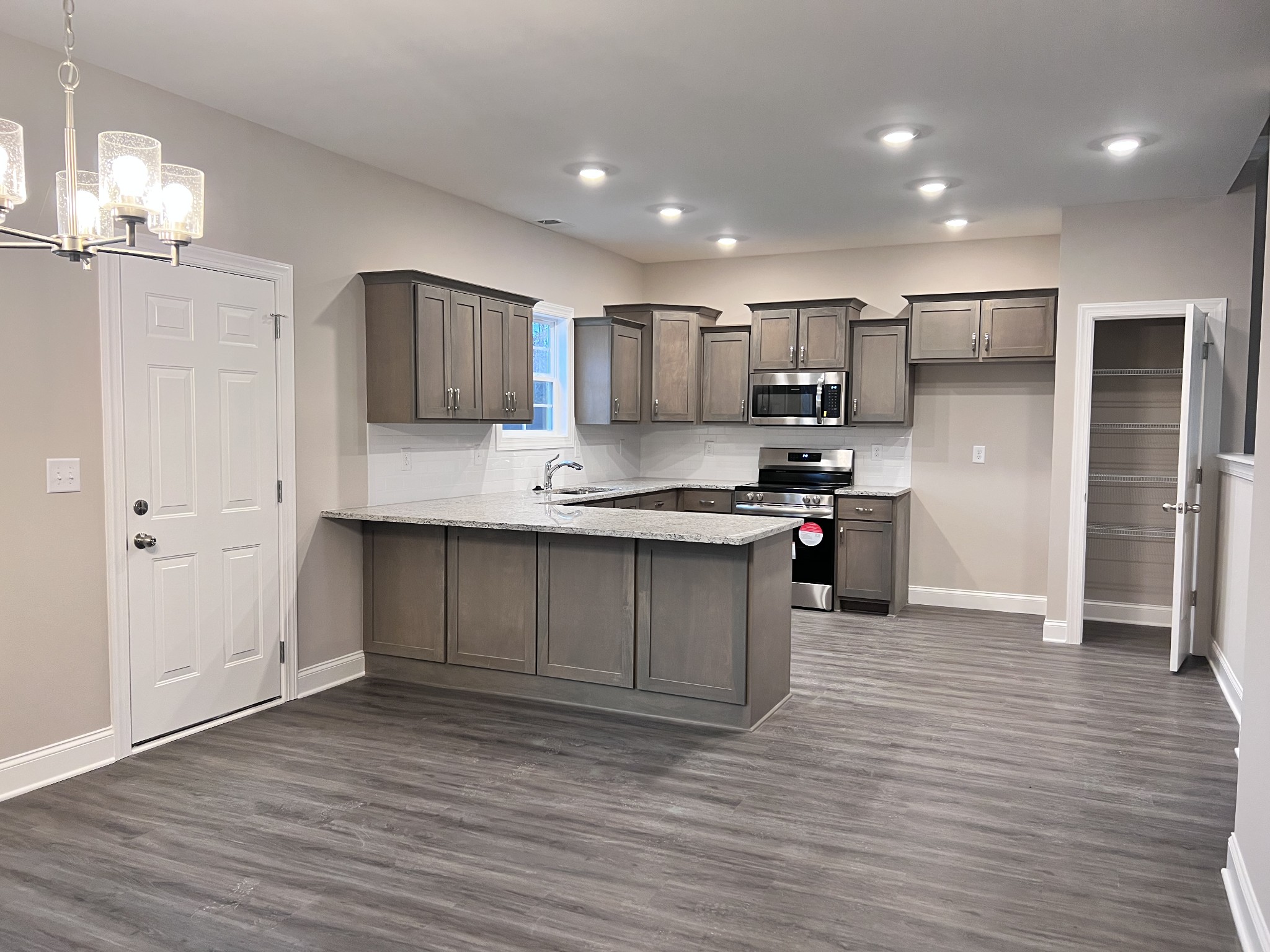 442 Generosity Way Smyrna, TN 37167 - Photo 31 of 59 a large kitchen with stainless steel appliances granite countertop a stove a sink and a refrigerator
