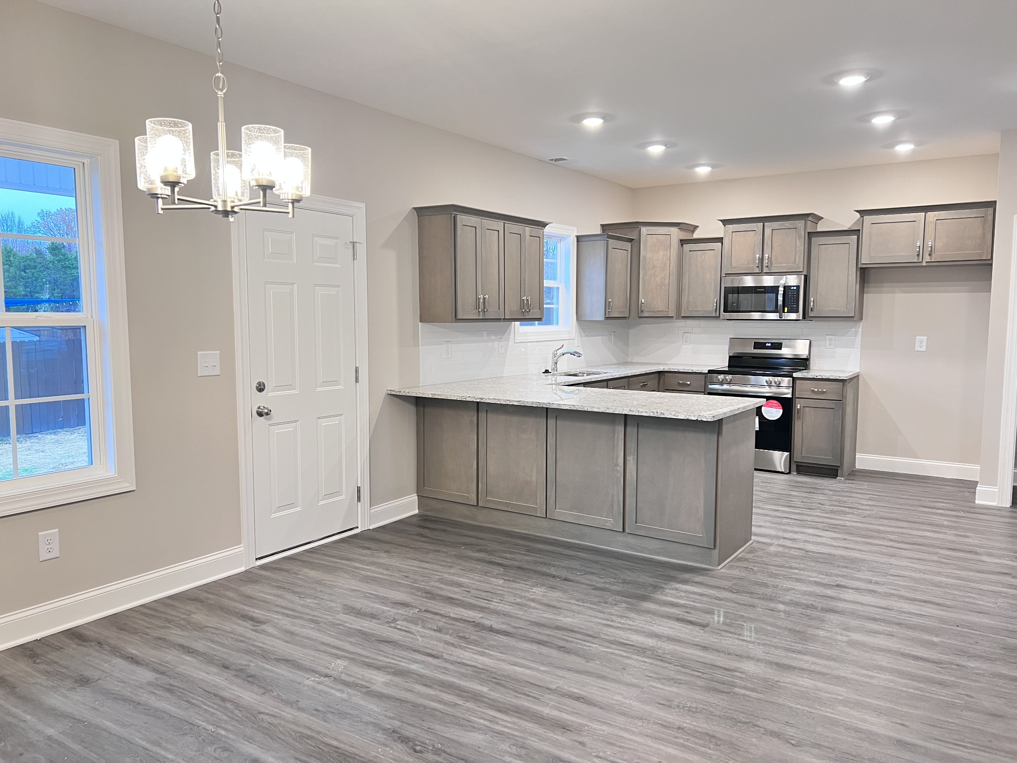442 Generosity Way Smyrna, TN 37167 - Photo 33 of 59 a kitchen with kitchen island a sink stainless steel appliances and cabinets