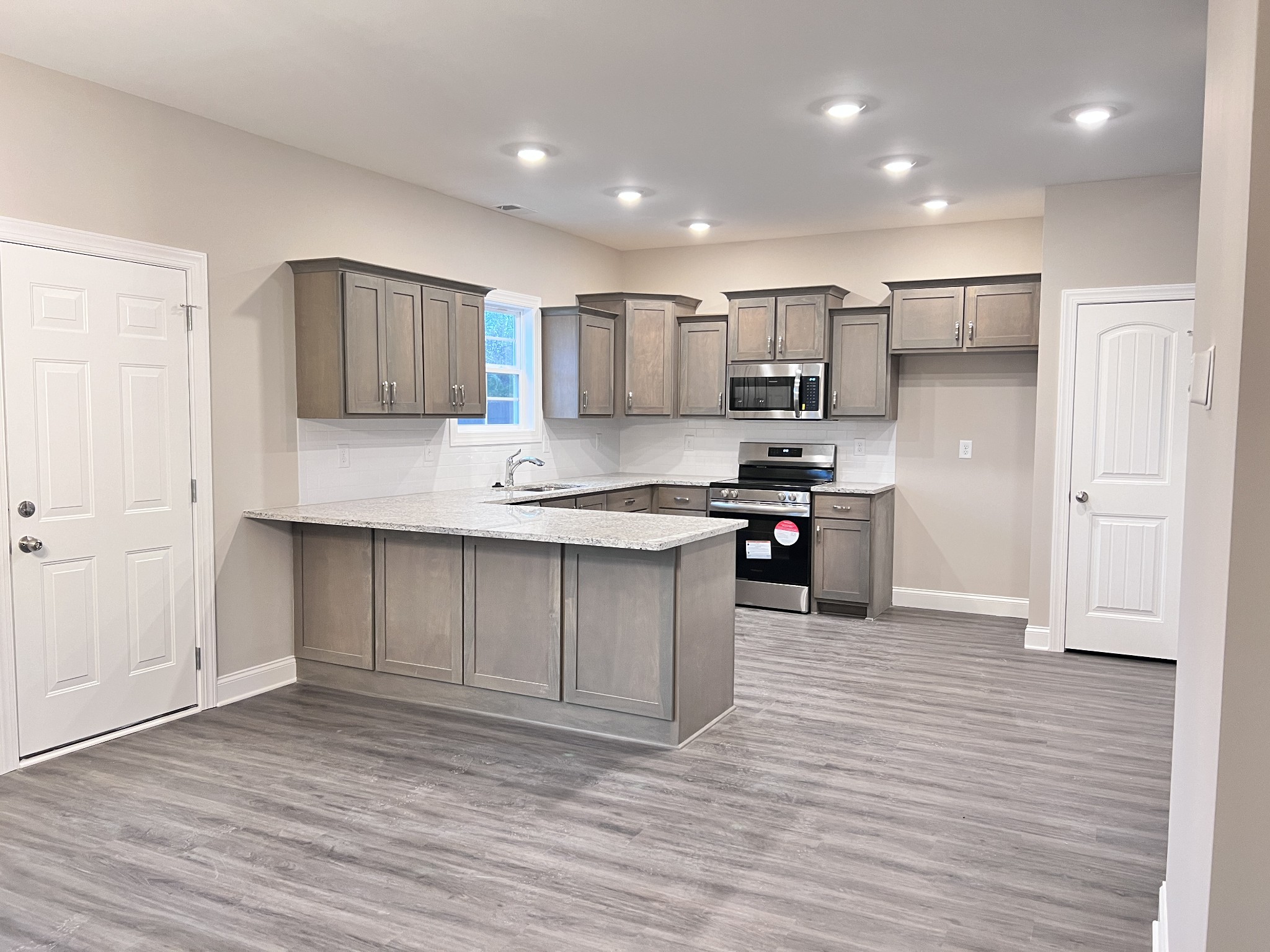 442 Generosity Way Smyrna, TN 37167 - Photo 36 of 59 a kitchen with stainless steel appliances granite countertop a refrigerator and a stove top oven