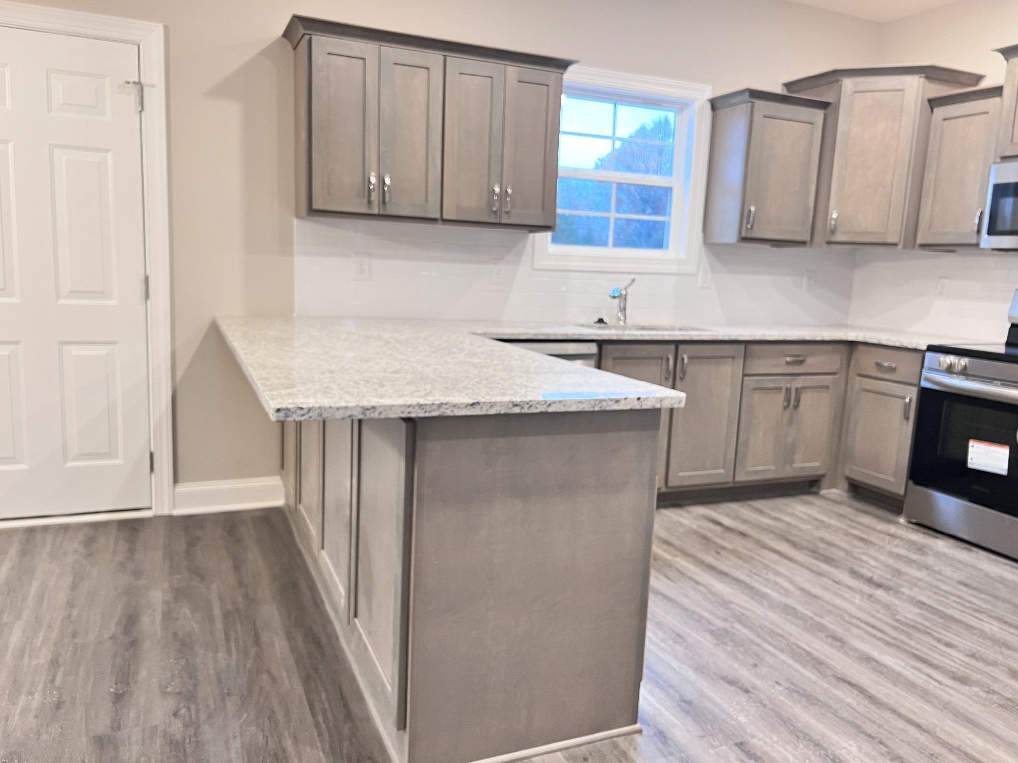 442 Generosity Way Smyrna, TN 37167 - Photo 4 of 59 a kitchen with stainless steel appliances granite countertop a sink stove and cabinets