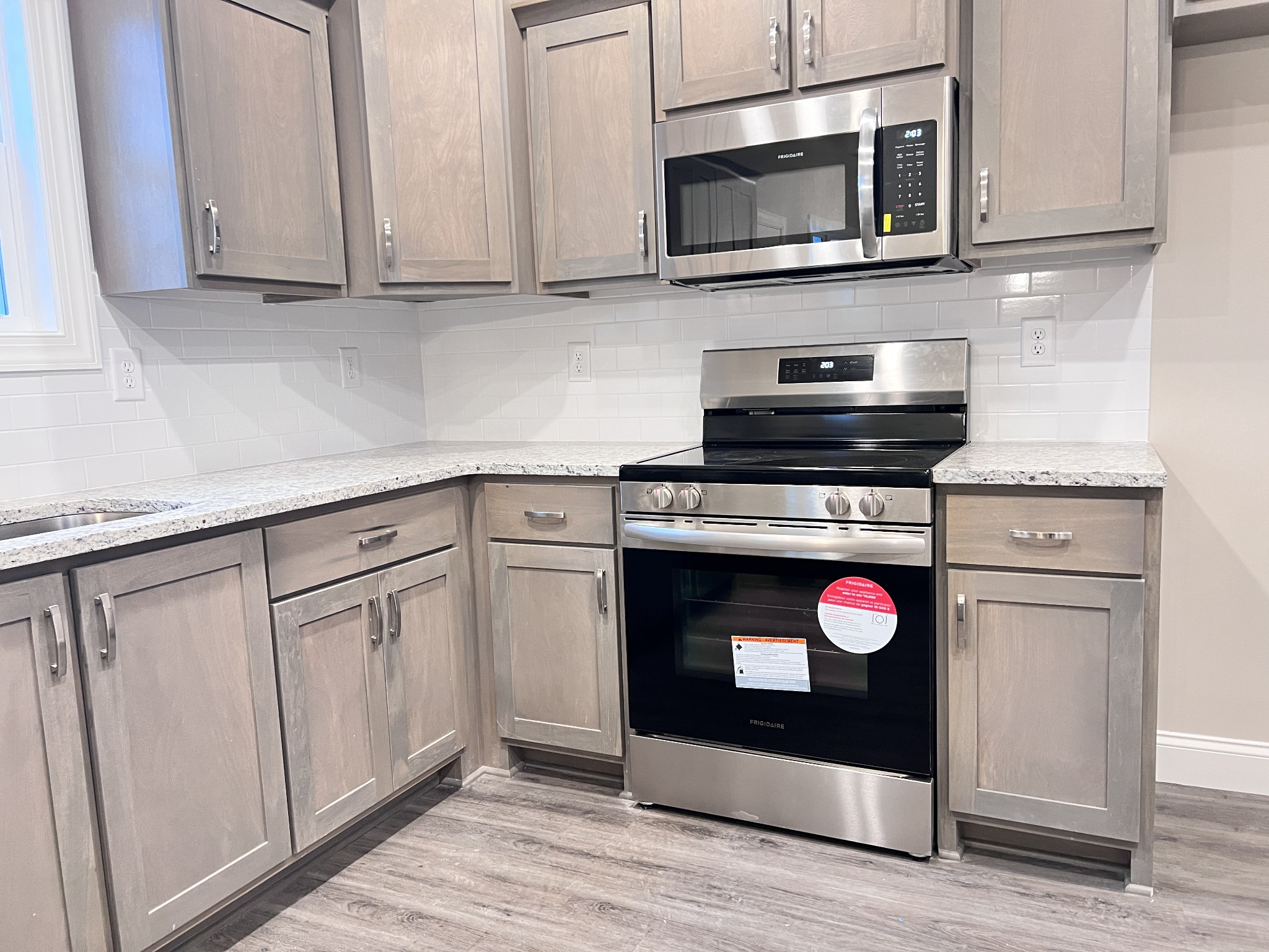 442 Generosity Way Smyrna, TN 37167 - Photo 48 of 59 a kitchen with stainless steel appliances granite countertop a stove microwave and sink