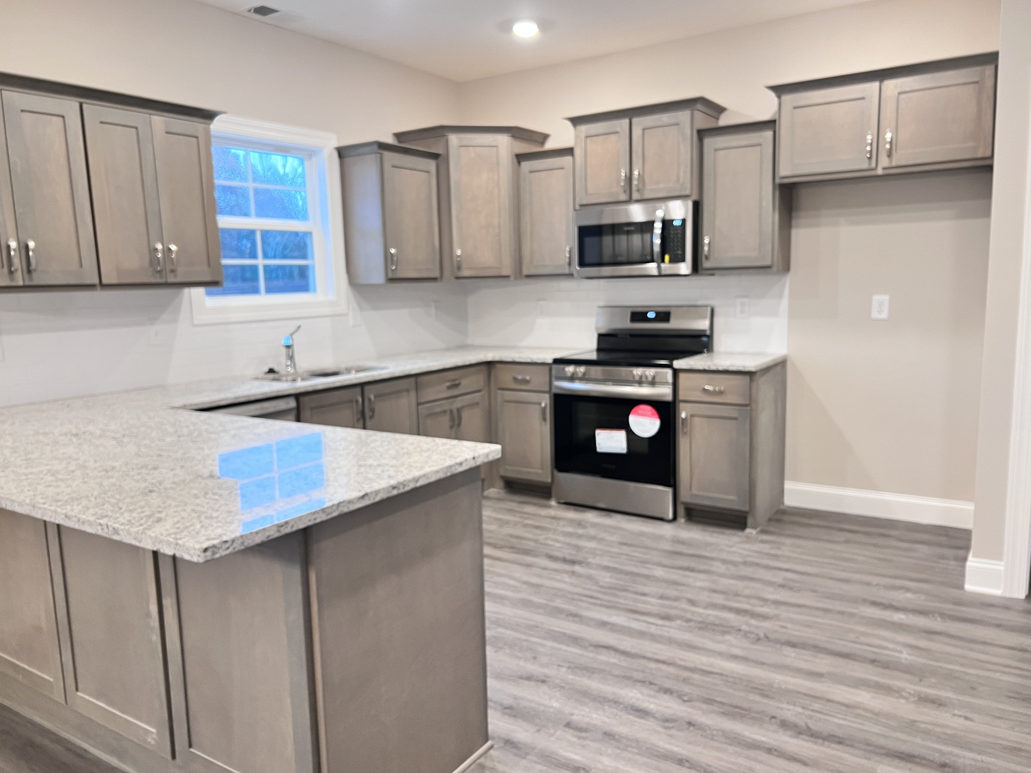 442 Generosity Way Smyrna, TN 37167 - Photo 7 of 59 a kitchen with stainless steel appliances granite countertop a sink stove and refrigerator