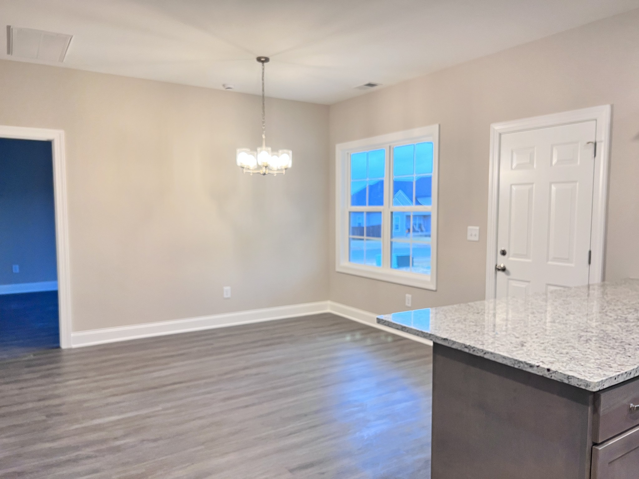 442 Generosity Way Smyrna, TN 37167 - Photo 8 of 59 an empty room with wooden floor and windows