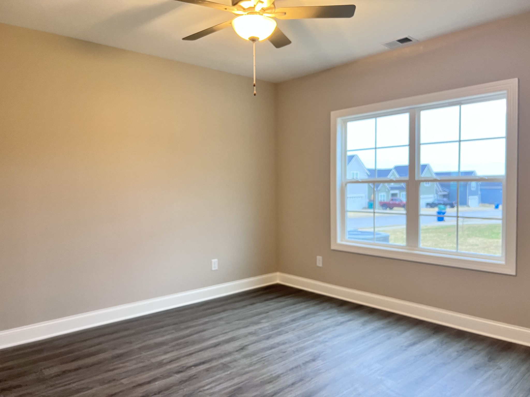 442 Generosity Way Smyrna, TN 37167 - Photo 9 of 59 a view of an empty room with wooden floor and a window