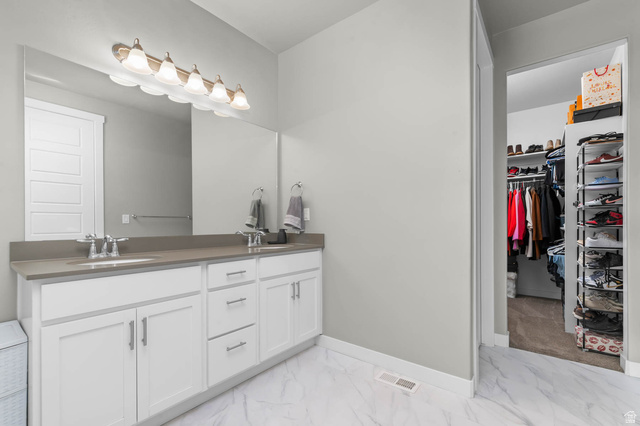 5686 Duke Lane Tooele, UT 84074 - Photo 21 of 38 Full bathroom with a walk in closet, double vanity, and light marble finish flooring