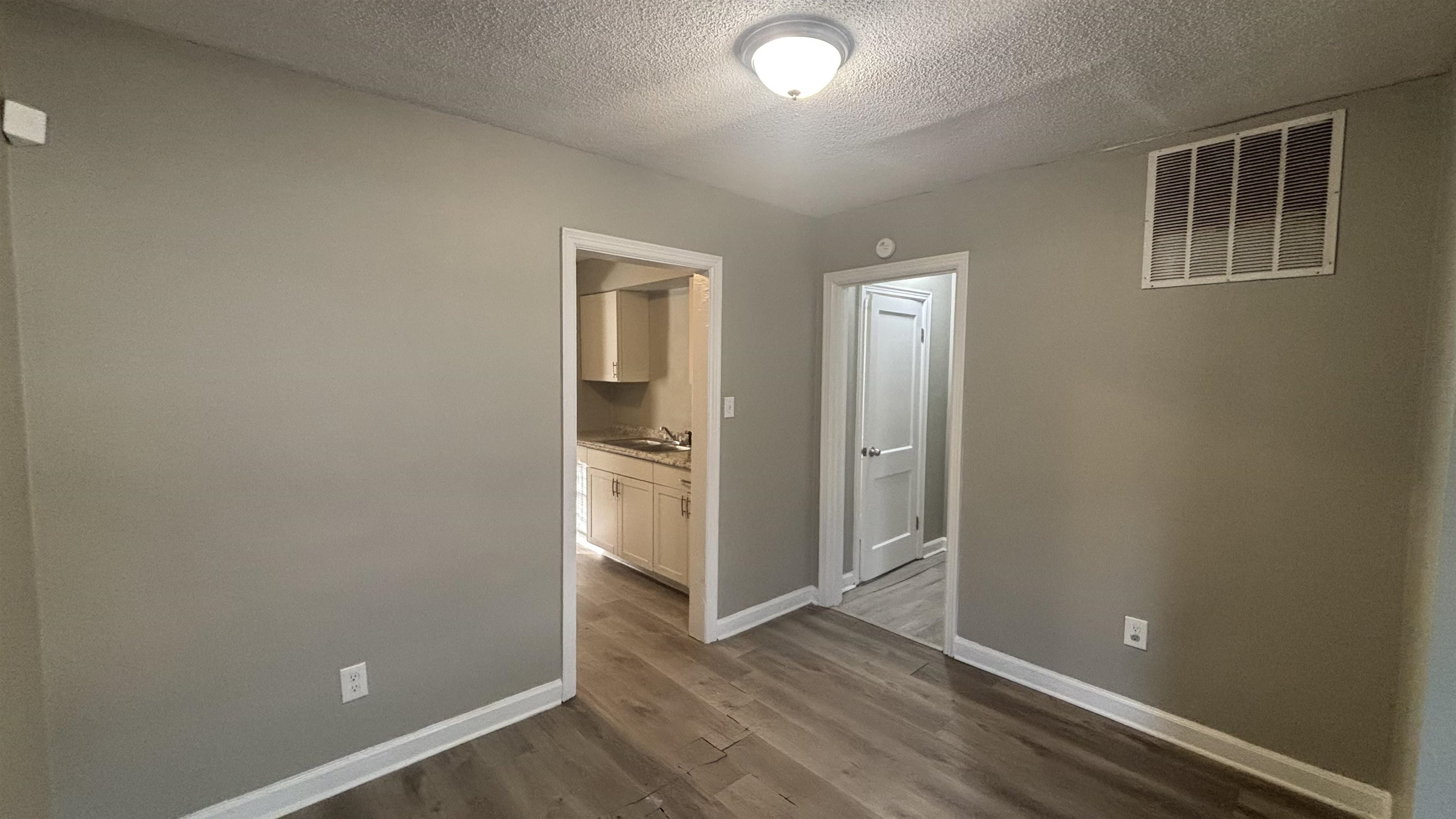 3133 Benjestown Road Memphis, TN 38127 - Photo 4 of 17 an empty room with closet and wooden floor