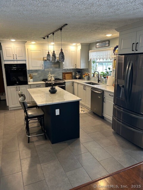 62 Cedarwood Road Berlin, CT 06037 - Photo 12 of 37 a kitchen with a sink a counter top space and stainless steel appliances
