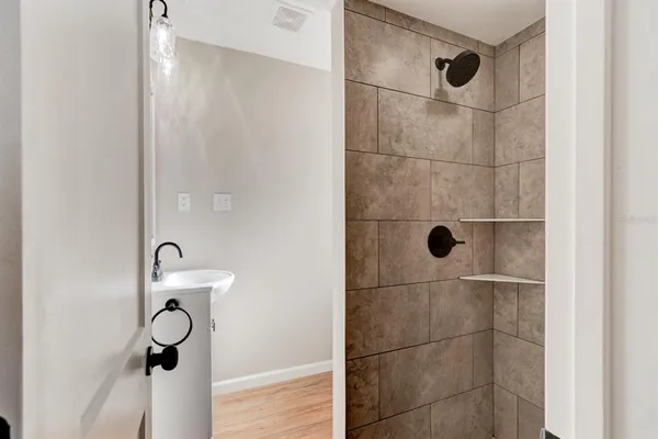 a bathroom with a glass shower door