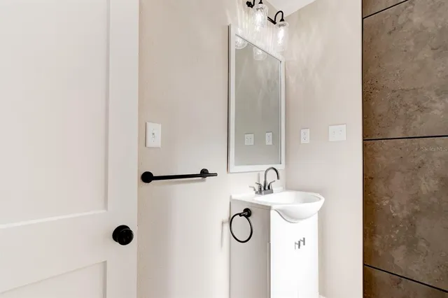 a bathroom with a sink and a mirror