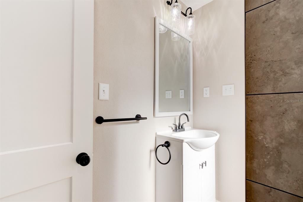 13 Highridge Road Daytona Beach, FL 32117 - Photo 16 of 27 a bathroom with a sink and a mirror