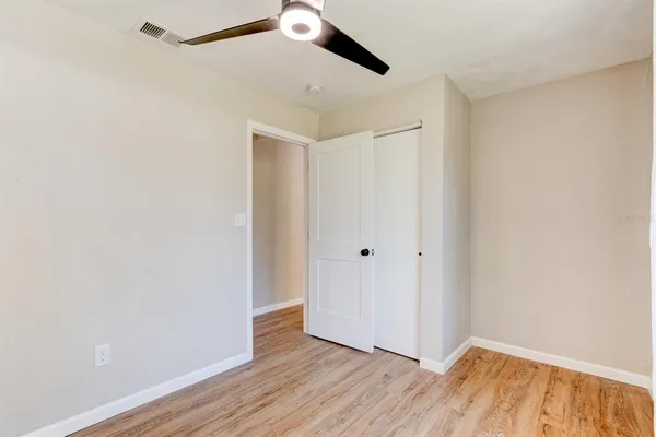 a view of an empty room with wooden floor