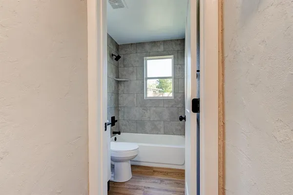 a bathroom with a toilet and a bathtub