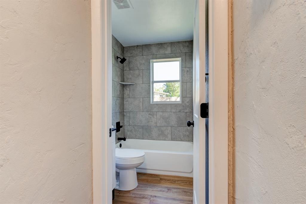13 Highridge Road Daytona Beach, FL 32117 - Photo 21 of 27 a bathroom with a toilet and a bathtub