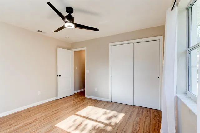 a view of an empty room and wooden floor