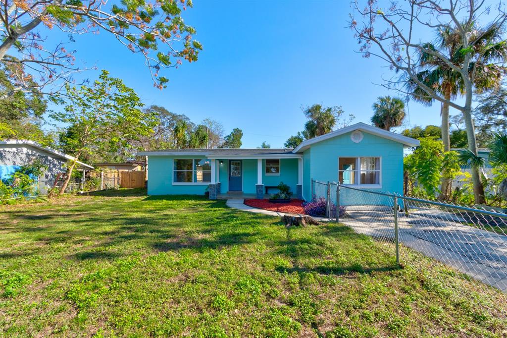 13 Highridge Road Daytona Beach, FL 32117 - Photo 3 of 27 a front view of a house with a garden and trees