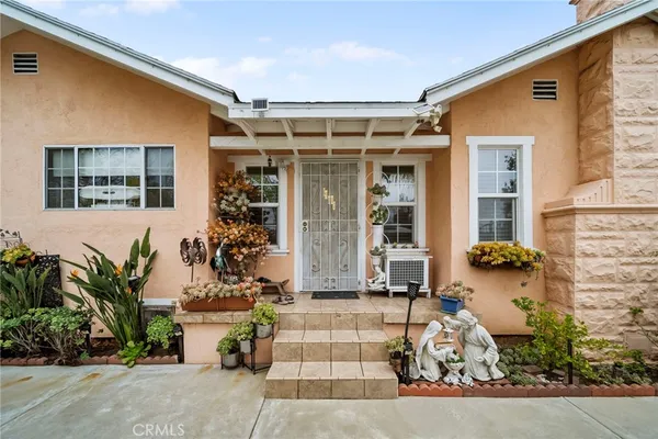 front view of a house with a potted plant and a couple of potted plants