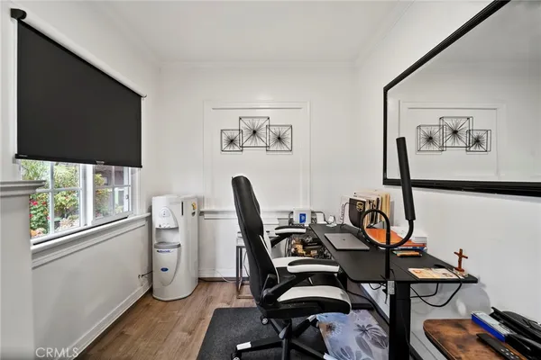 a view of a workspace with furniture and a window