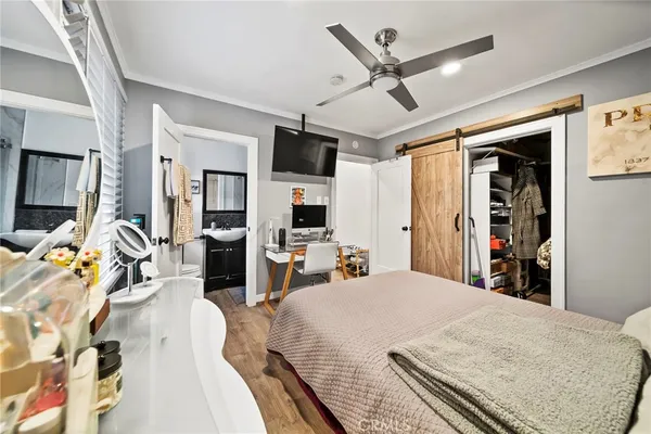 a bed room with a bed a flat screen tv and a couch