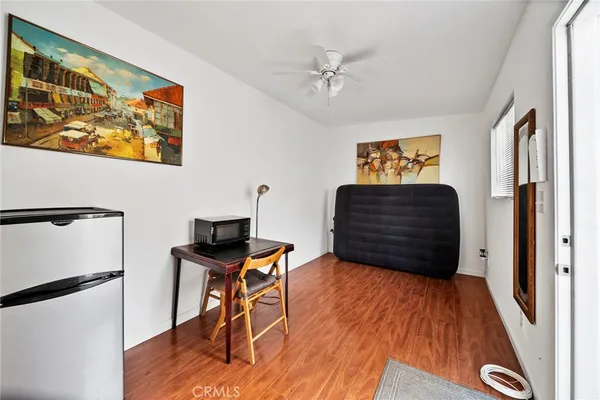 a view of a workspace with furniture and wooden floor