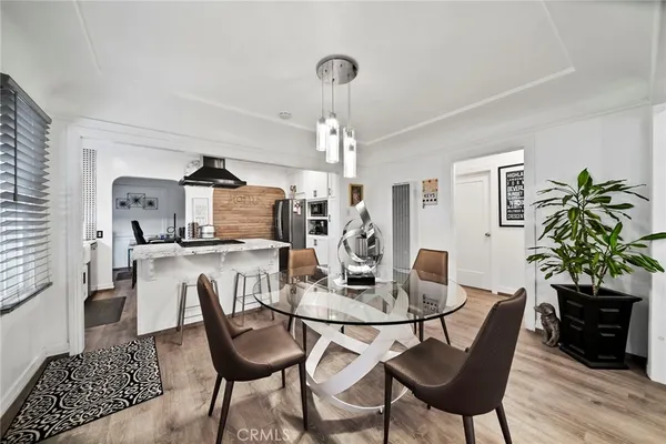 a view of a dining room with furniture and wooden floor