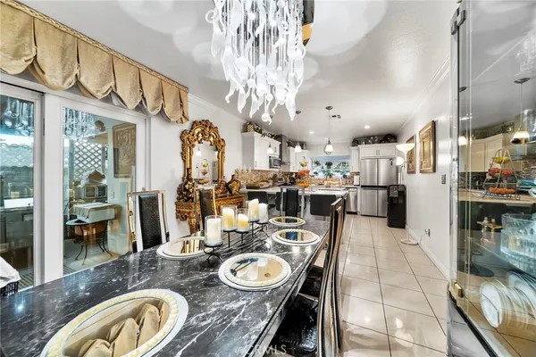 a dining room with furniture a chandelier and wooden floor