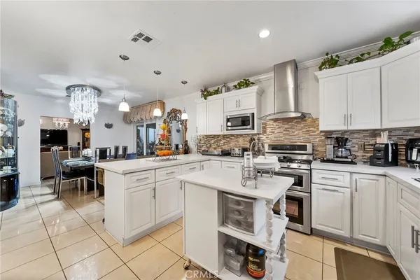 a kitchen with appliances a sink and cabinets