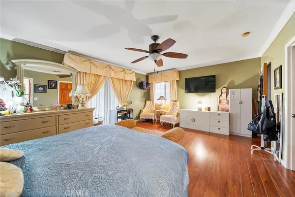 a spacious bathroom with a toilet a double vanity sink and a mirror