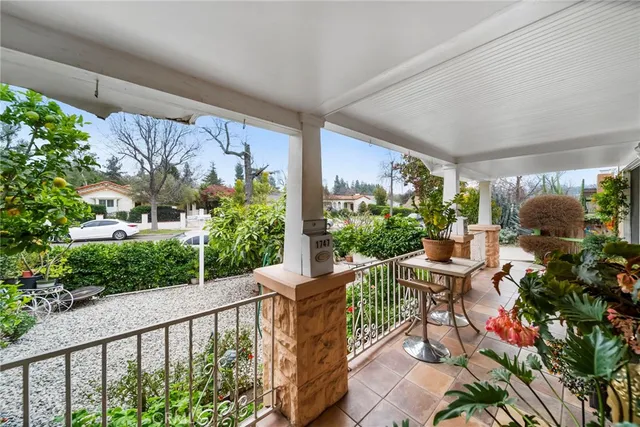 front view of a house with a potted plant and a couple of potted plants