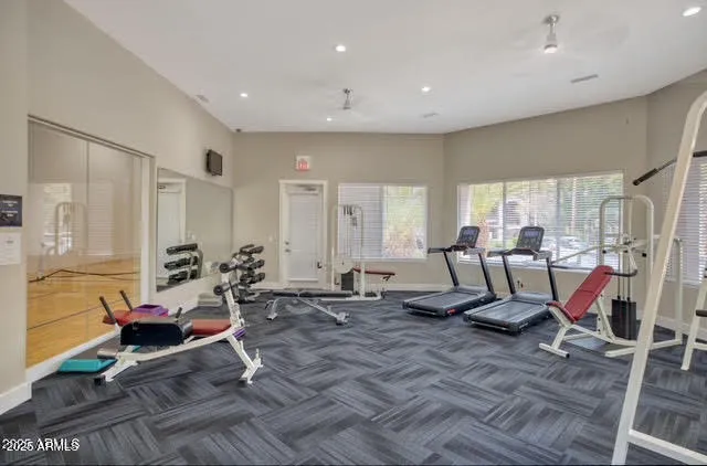 a living room with furniture a window and gym equipment