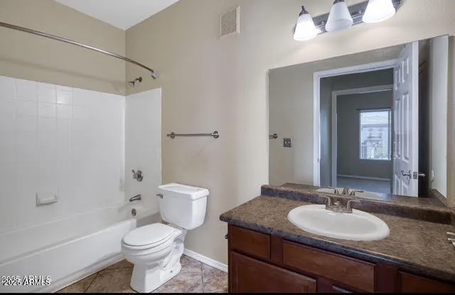 a bathroom with a granite countertop sink toilet a mirror and a bathtub