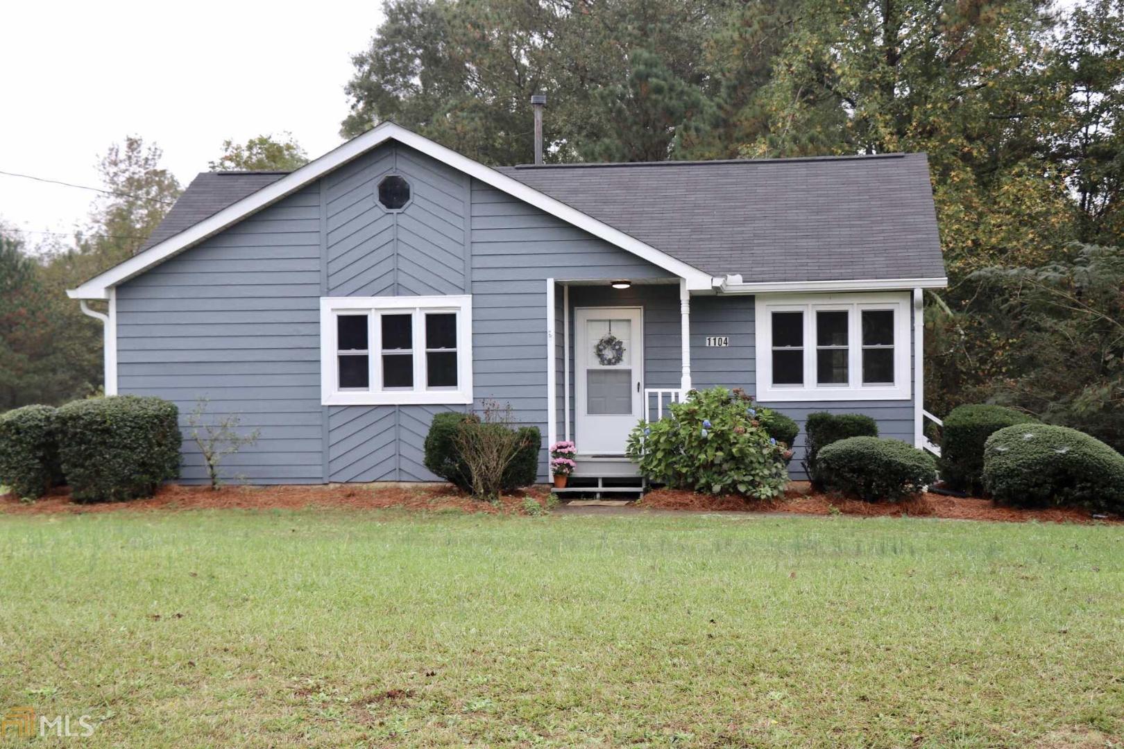 1104 Needmore Road Roopville, GA 30170 - Photo 1 of 1 a view of a house with a yard and plants
