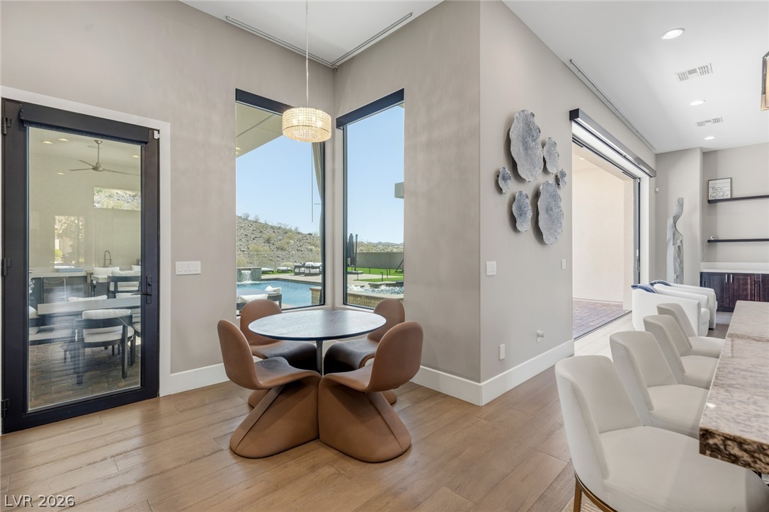 5 Crystal Tree Pass Henderson, NV 89052 - Photo 16 of 67 Floor-to-ceiling windows and a sliding glass door offer sweeping views of the desert landscape and inviting pool area.