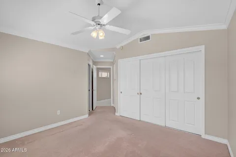 an empty room with a ceiling fan and a window