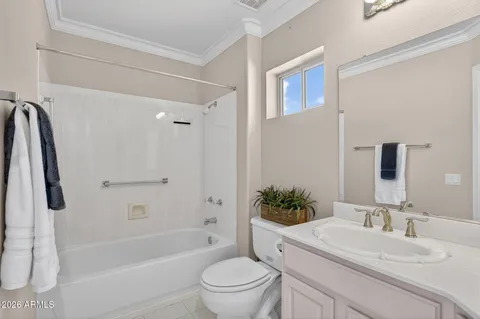 a bathroom with a granite countertop sink a toilet and a bathtub