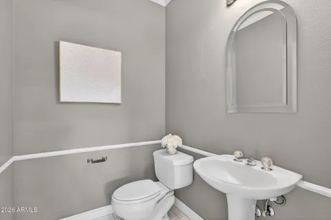 a bathroom with a sink mirror and toilet