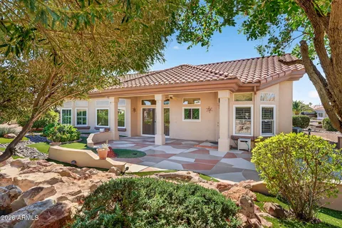 a view of a house with backyard sitting area and garden