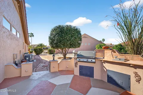 a kitchen with stainless steel appliances granite countertop a stove and a couch