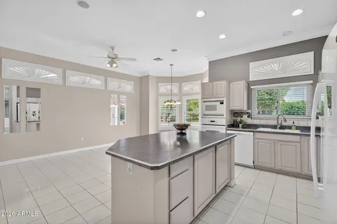 a kitchen with a sink window and cabinets