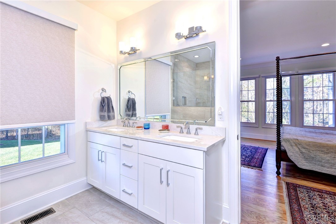 112 Nottinghamshire Williamsburg, VA 23188 - Photo 27 of 50 a en suite bathroom with a granite countertop double vanity sink a mirror and a bathtub