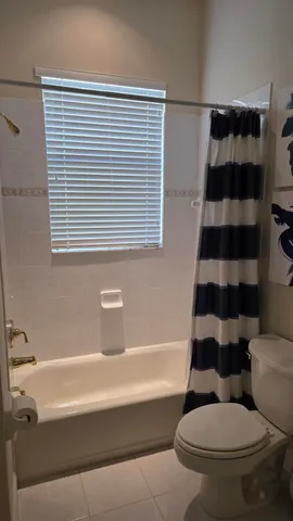 a bathroom with a toilet and a window