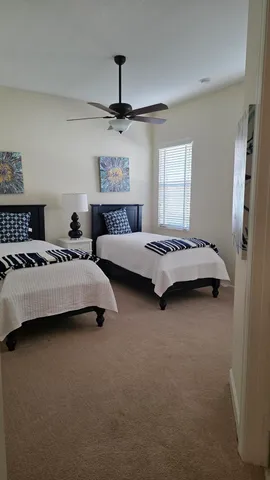 a living room with furniture a large window and a dining table