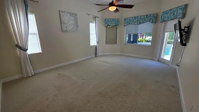 a view of a patio with table and chairs potted plants with floor to ceiling window
