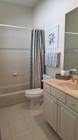 a white toilet sitting next to a bathroom sink
